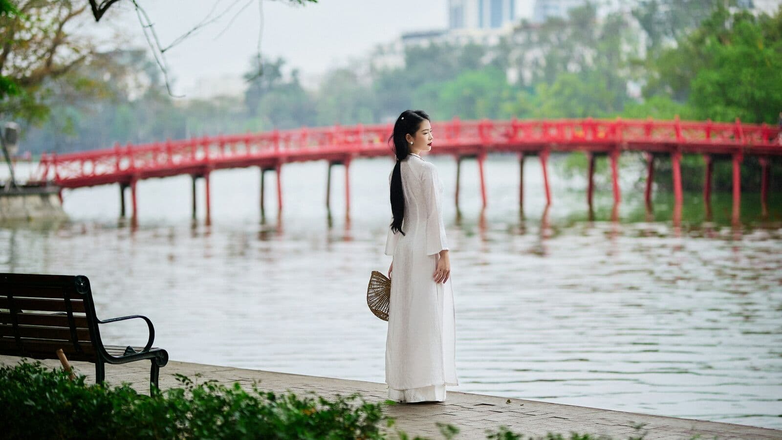 Woman in a white ao dai by The Huc Bridge, Hoan Kiem Lake