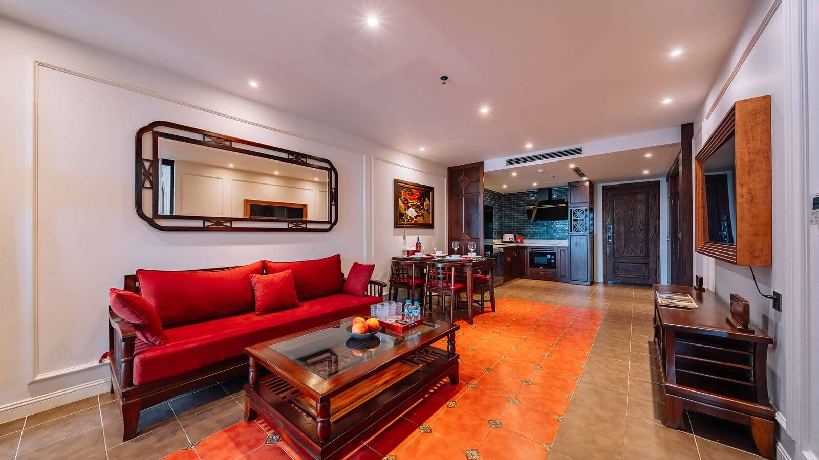 Living room with a red sofa in a Two-Bedroom Deluxe Apartment