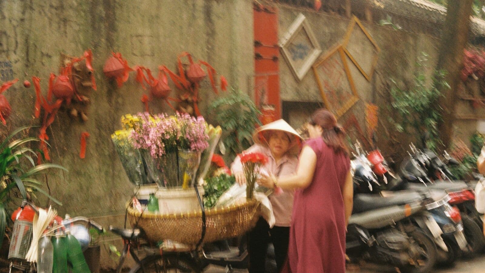 Flower seller with a bicycle cart on a Hanoi street